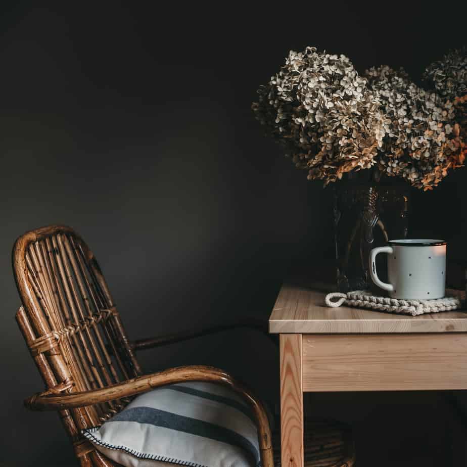 chair and desk with hydrangeas and coffee sitting on top