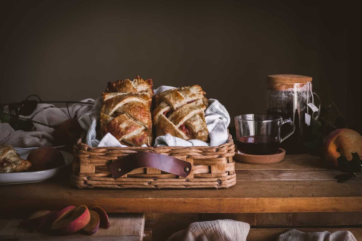 plate with pie, hand pies and tea on a table