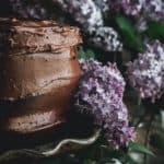 closeup of chocolate cake and lilac blossoms