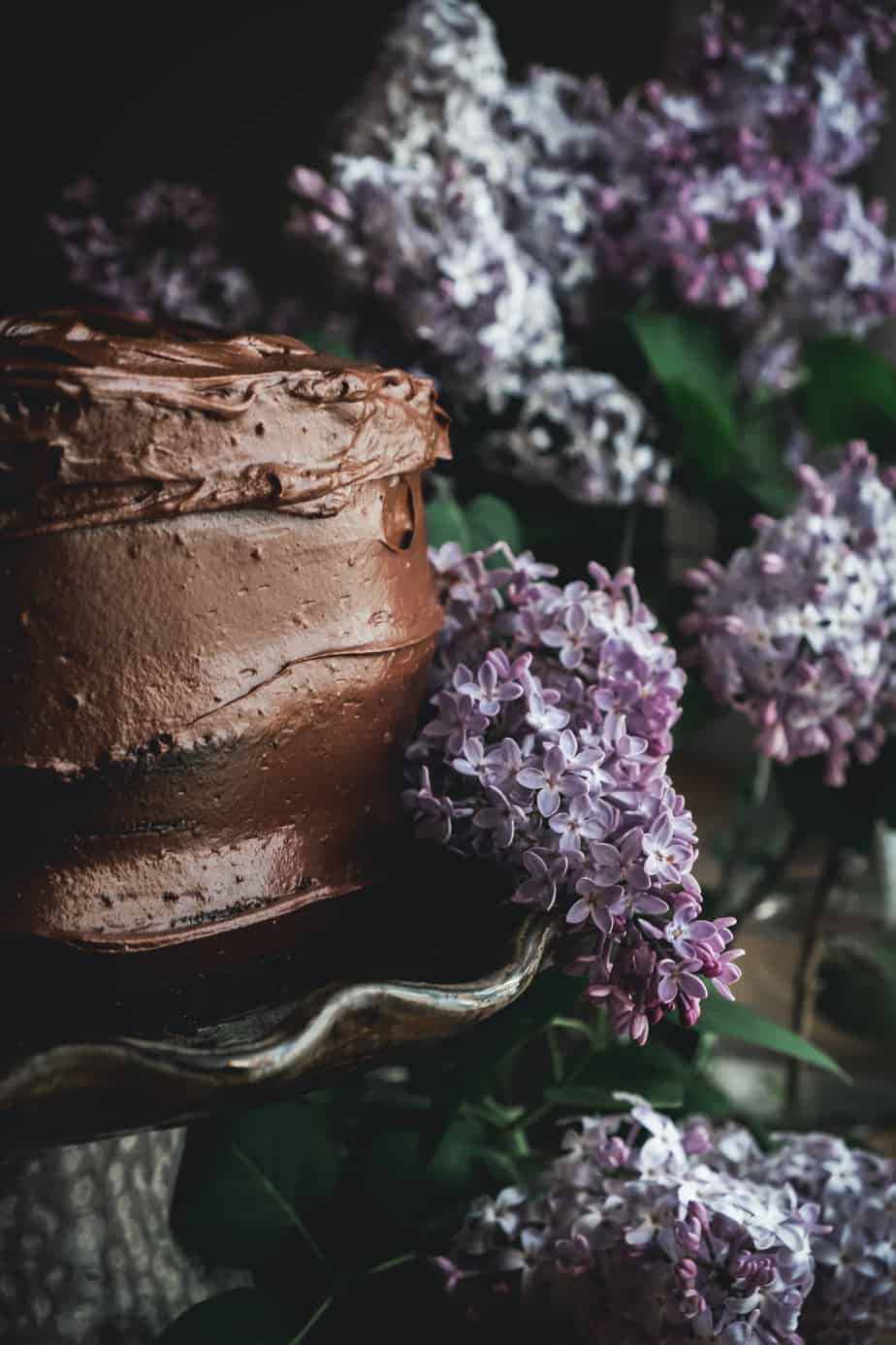 closeup of chocolate cake and lilac blossoms