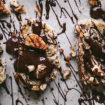 flatlay of biscotti cookies with chocolate drizzle and pecans