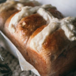 closeup of hot cross milk bread on table