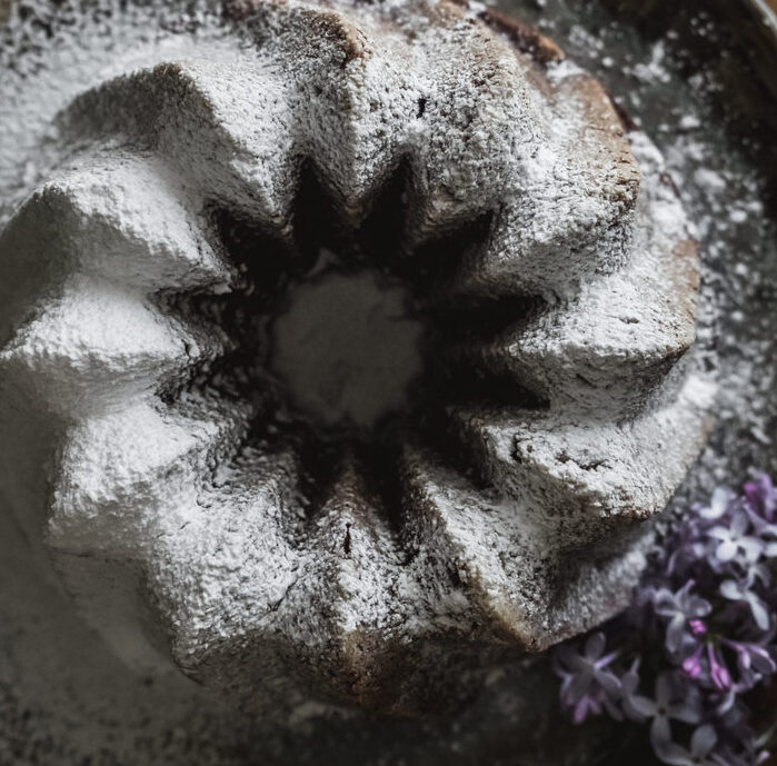 flatlay of chocolate zucchini cake covered in powdered sugar