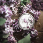 flatlay of lilac sugar jar next to lilac flowers