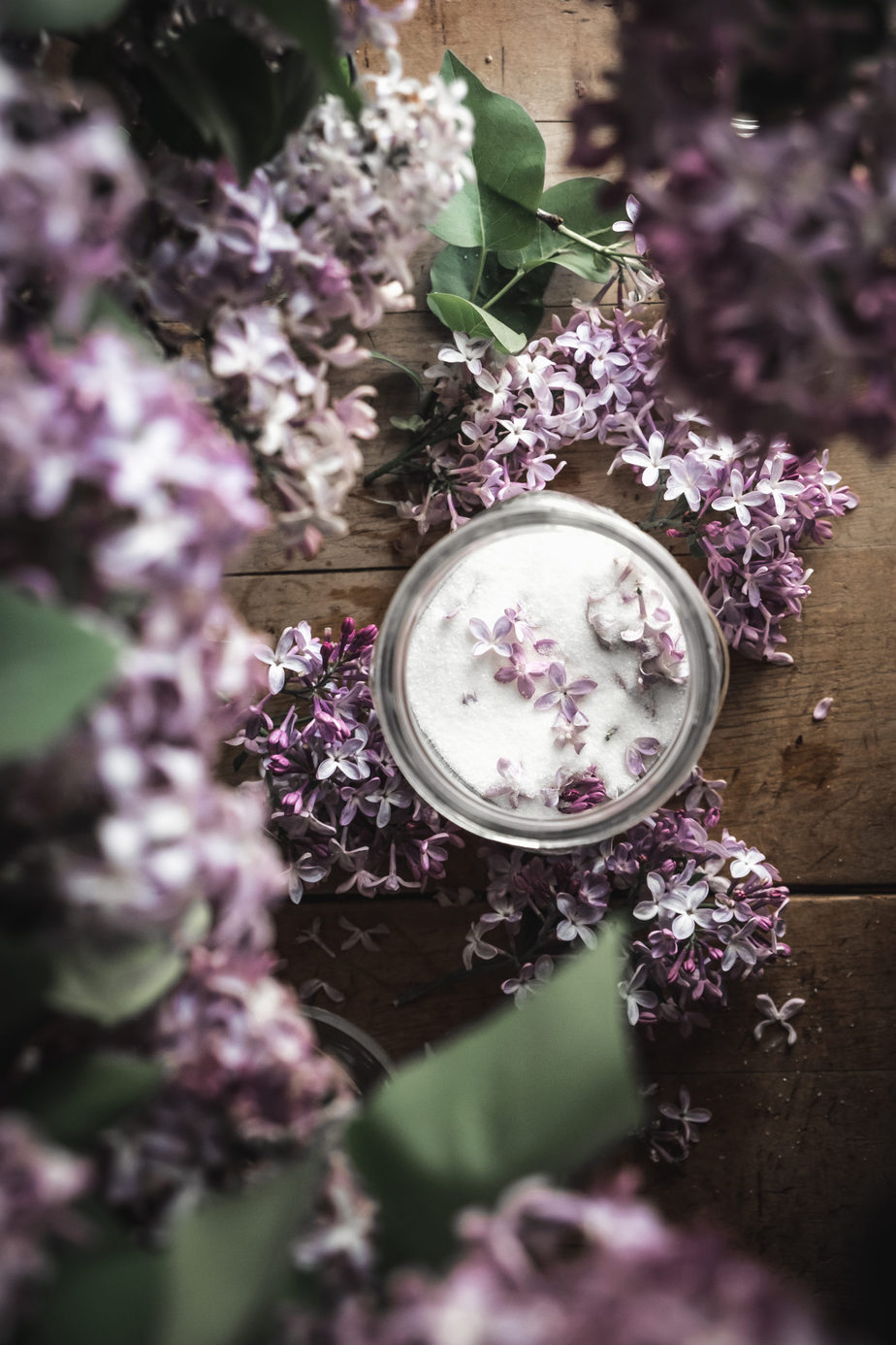 flatlay of lilac sugar jar next to lilac flowers