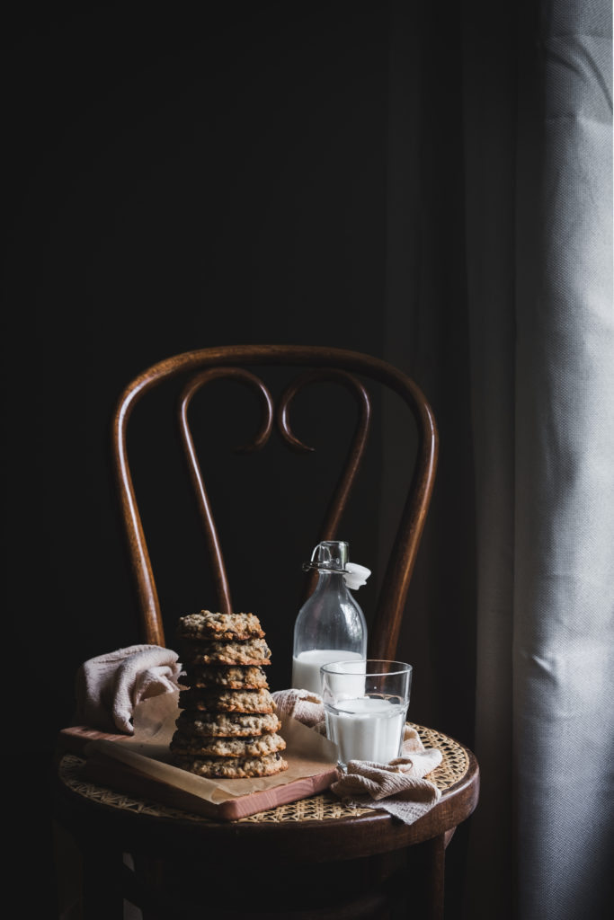 oatmeal raisin cookies and milk glass on a chair