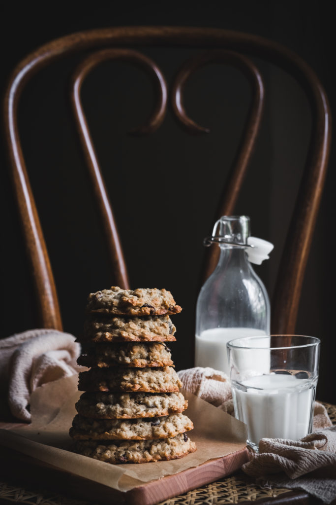 oatmeal raisin cookies and milk glass on a chair